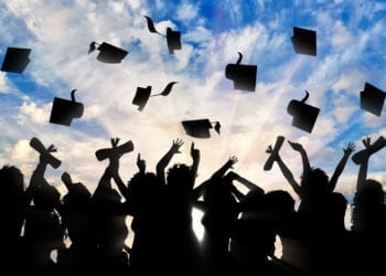 Students graduate cap throwing in sky. Study concept