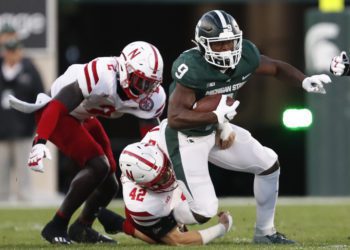 Sep 25, 2021; East Lansing, Michigan, USA; Michigan State Spartans running back Kenneth Walker III (9) gets tackled by Nebraska Cornhuskers linebacker Nick Henrich (42) during the first quarter at Spartan Stadium. Mandatory Credit: Raj Mehta-USA TODAY Sports
