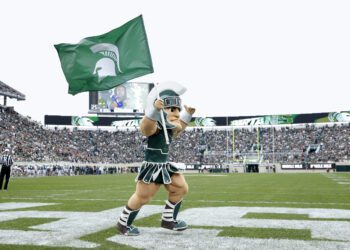 EAST LANSING, MI - SEPTEMBER 28: Michigan State Spartans mascot Sparty carries the school flag after a touchdown during a game against the Indiana Hoosiers at Spartan Stadium on September 28, 2019 in East Lansing, Michigan. Michigan State defeated Indiana 40-31. (Photo by Joe Robbins/Getty Images)